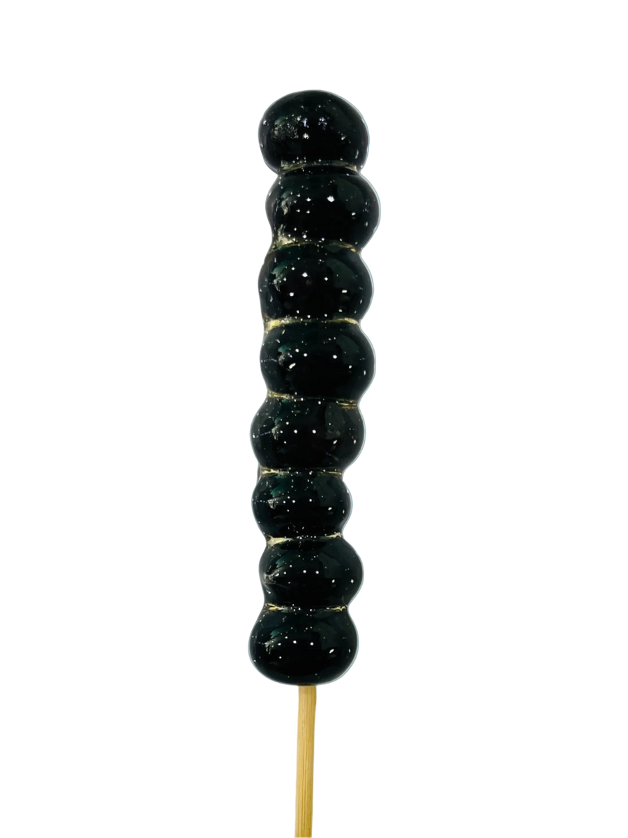 Blueberry tanghulu skewer with glossy crystal sugar shell on a pale blue background
