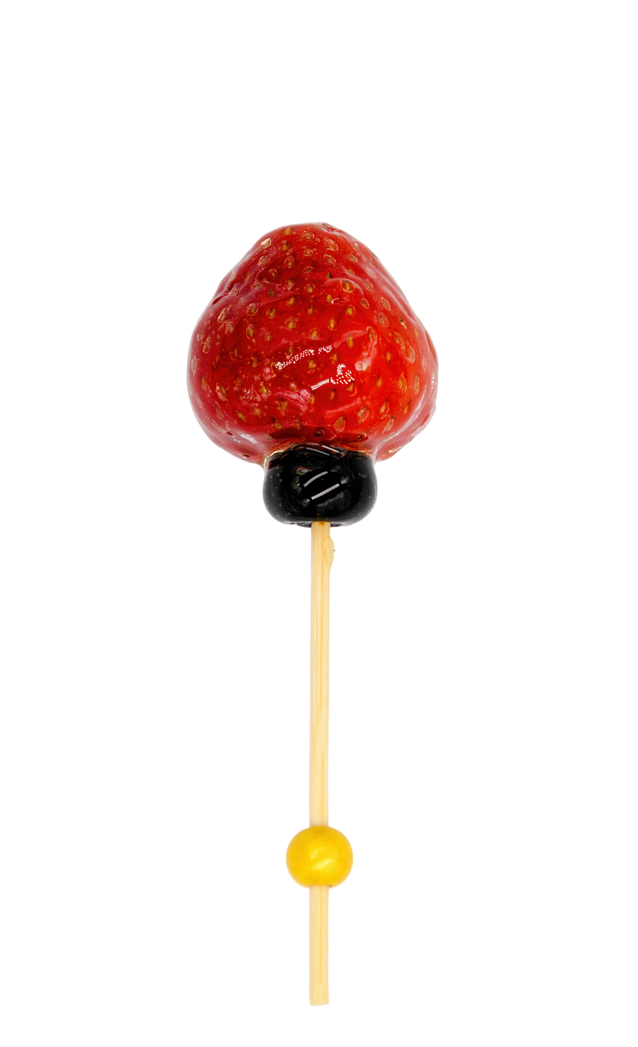 Glazed Strawberry tanghulu on a stick with a blueberry and cocktail pick. 