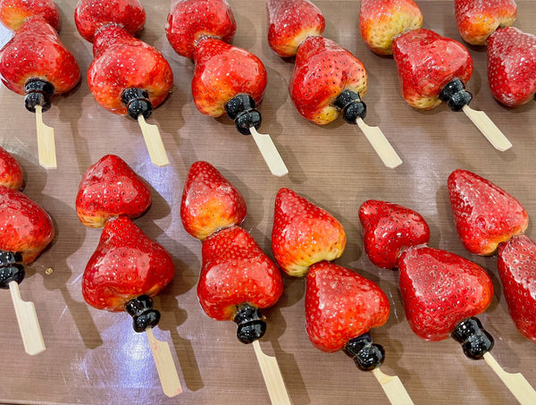Tanghulu catering display at a Bay Area event — crystal-glazed fruit skewers